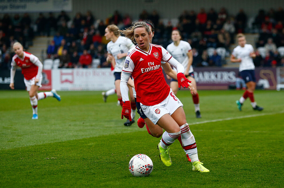 Image showing an Arsenal player in action wearing the WSL badge
