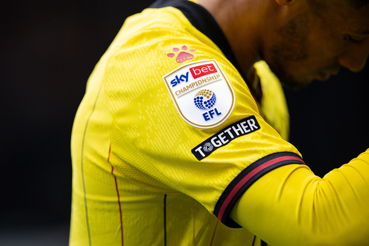 Image showing a Watford players sleeve with the EFL Championship badge on his sleeve
