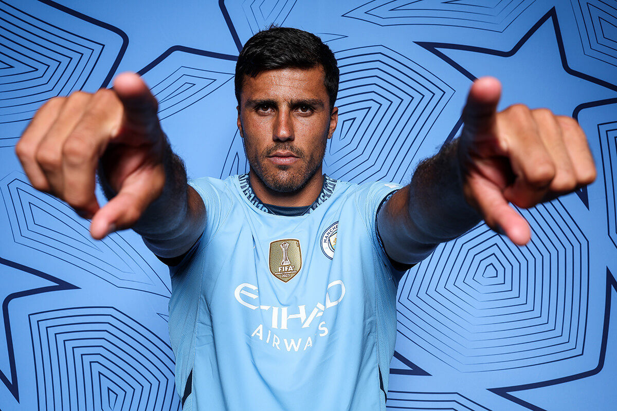 Image showing Rodri pointing at the camera witht he Fifa world champions badge on his chest