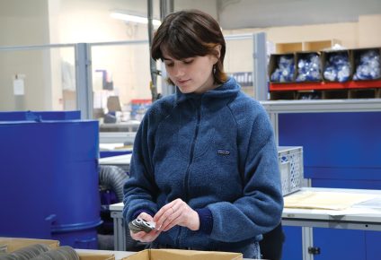 Image showing a worker at Elms handling UEFA badges