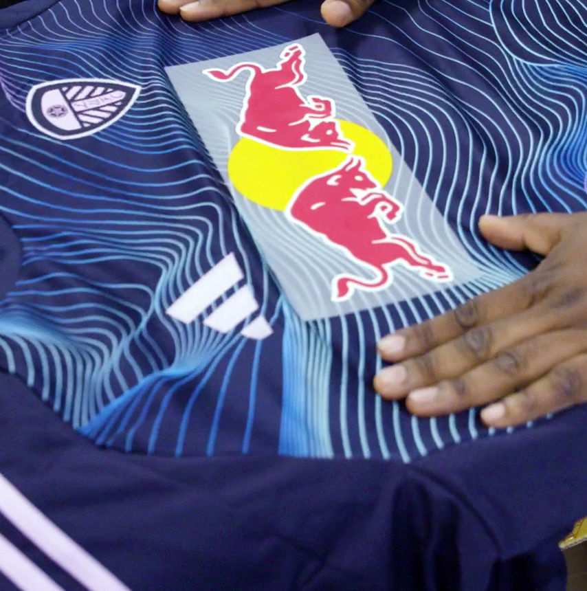 Image showing a Red Bull sponsorship being applied to a jersey