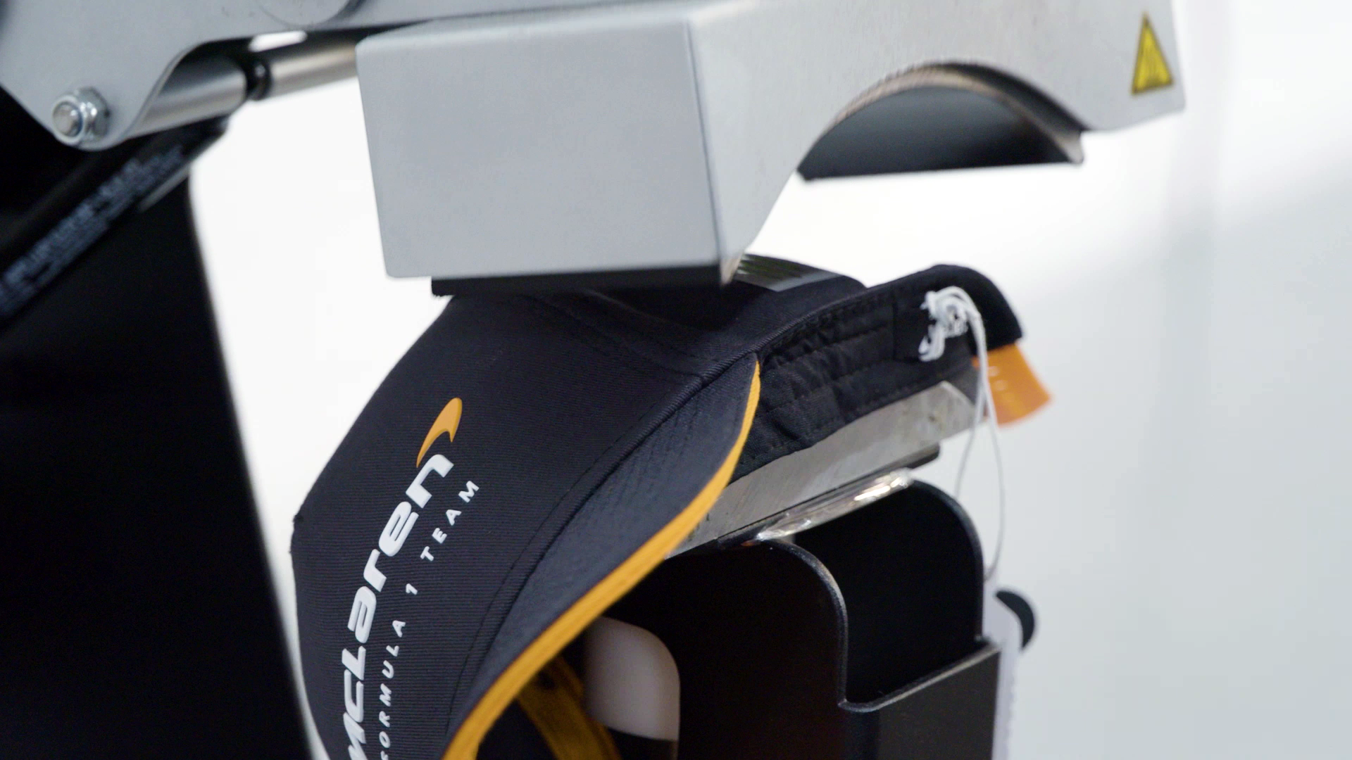 Image showing a McLaren cap being heat pressed upon